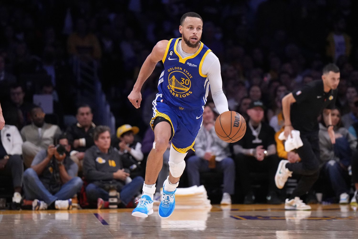 Golden State Warriors guard Stephen Curry dribbles the ball against the Los Angeles Lakers.